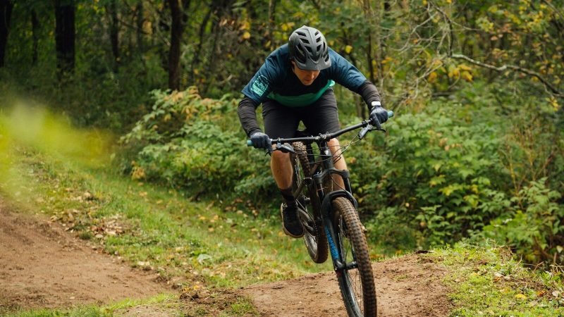 a man riding a bike down a dirt road