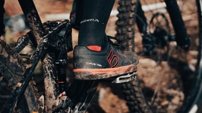 A dynamic shot of a cyclist's shoe on a muddy mountain bike pedal, emphasizing adventure and outdoor biking.