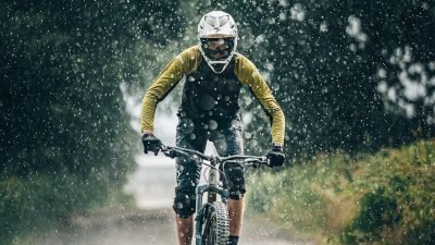 man in black jacket riding bicycle on road during daytime